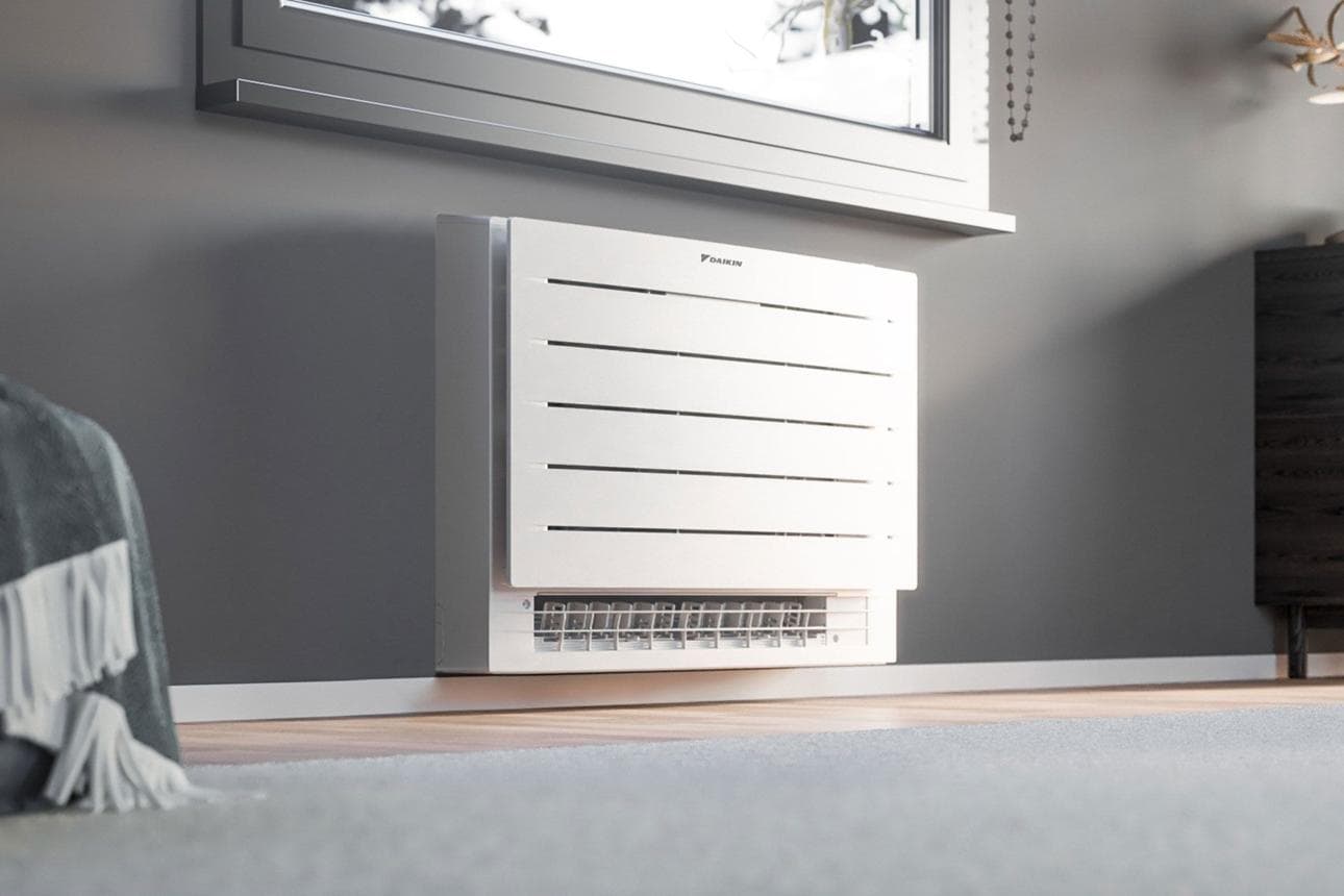 Floor-mounted mini split console installed beneath a window